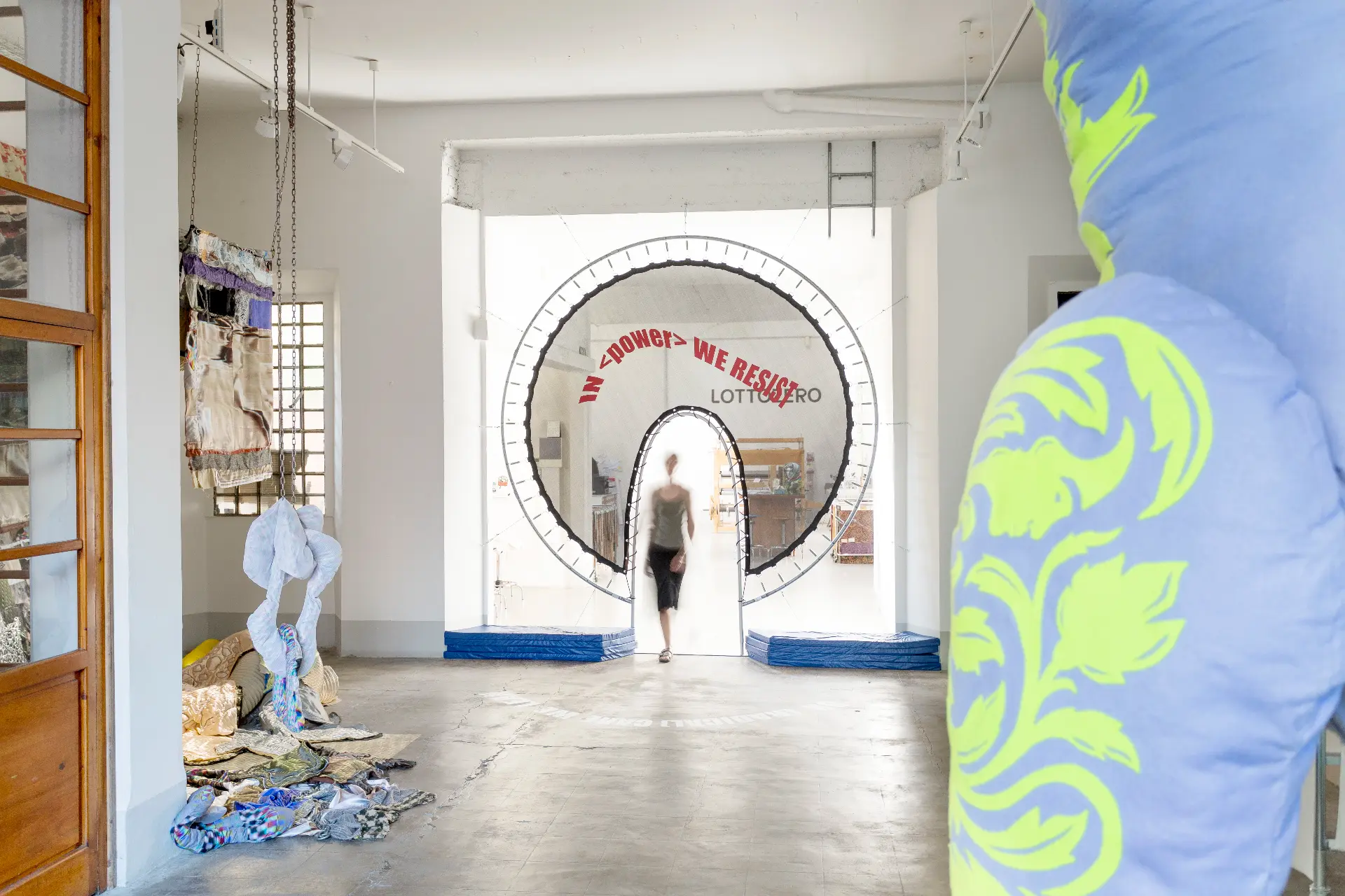 Radical Power — installation view with visitor crossing the threshold