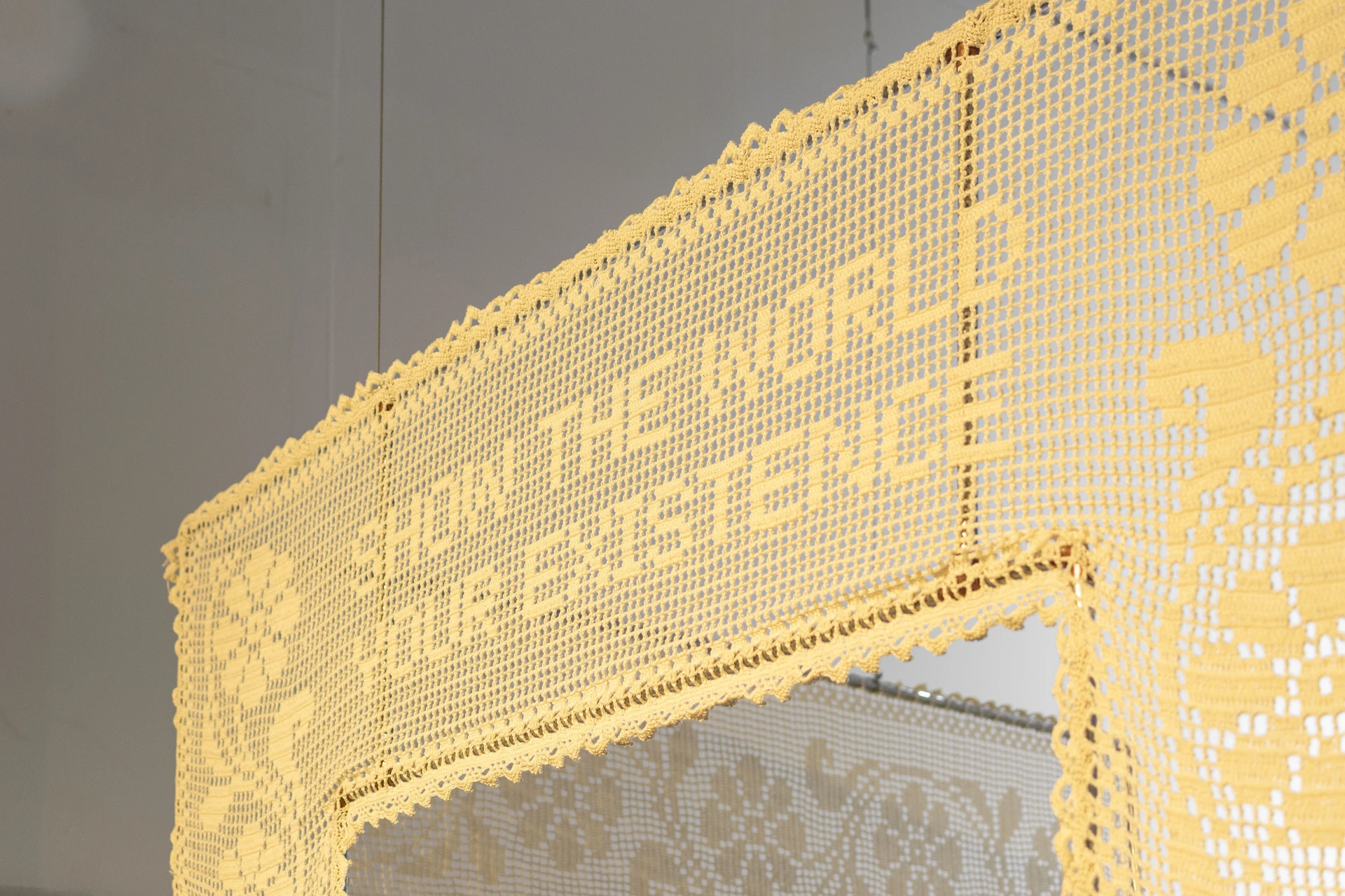 Show the World Your Existence, 2025 — filet crochet detail with the embroidered phrase
