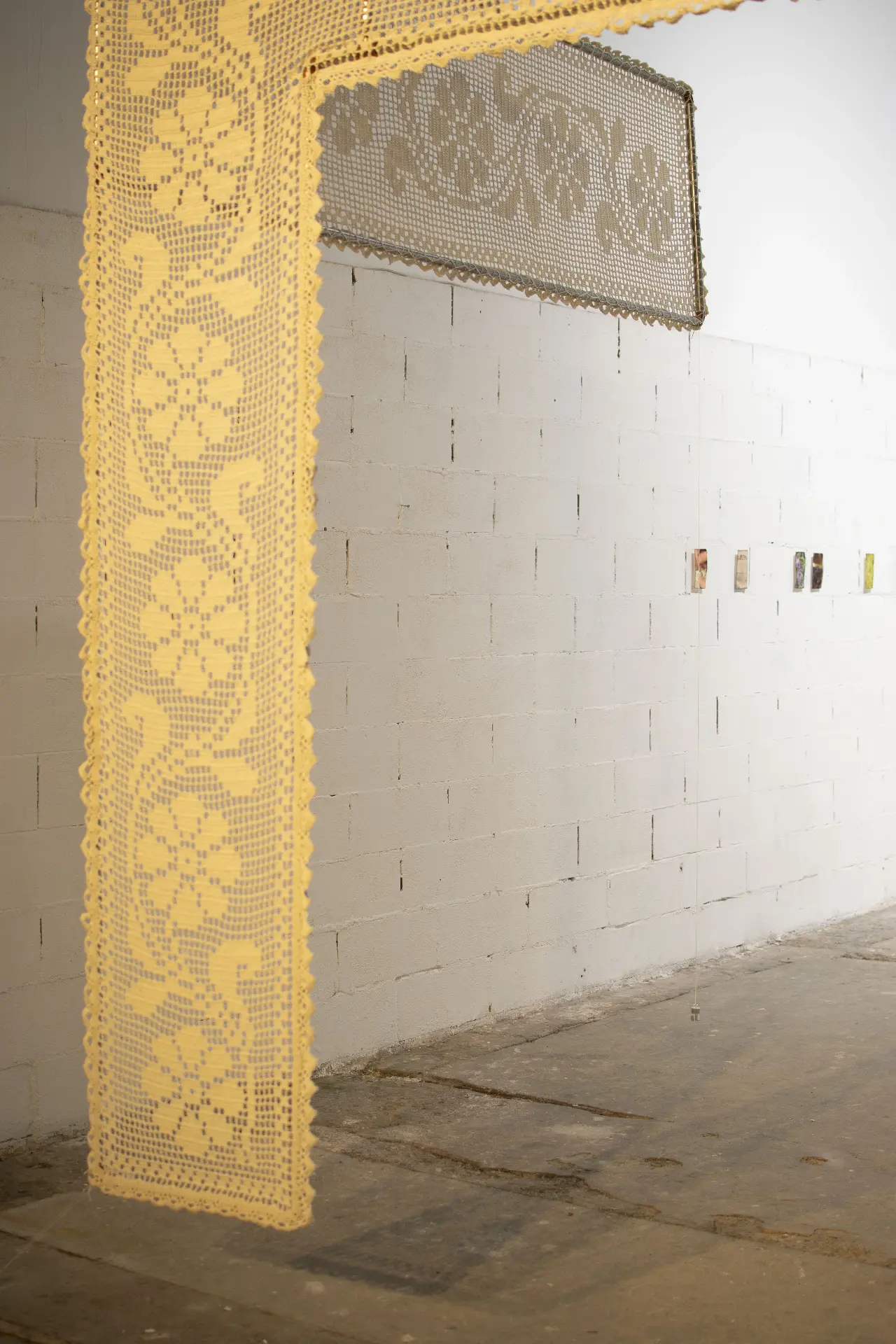 Show the World Your Existence — detail of the crochet panel against the exhibition wall